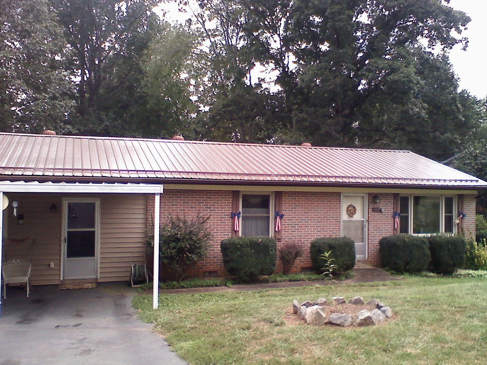 Bronze metal roof and carport on a brick ranch home — Roof Repair work by our crew in Elk Grove